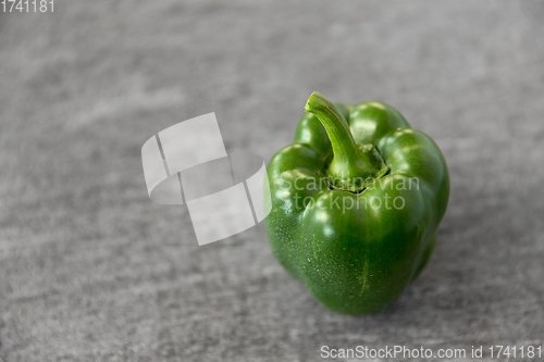 Image of close up of green pepper on slate stone background