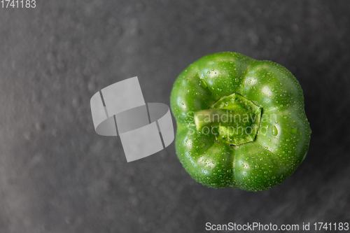 Image of close up of green pepper on slate stone background