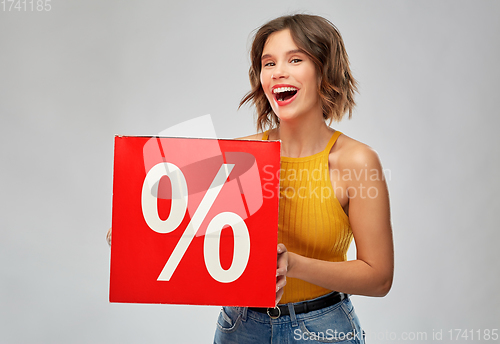 Image of happy smiling young woman with sale signs