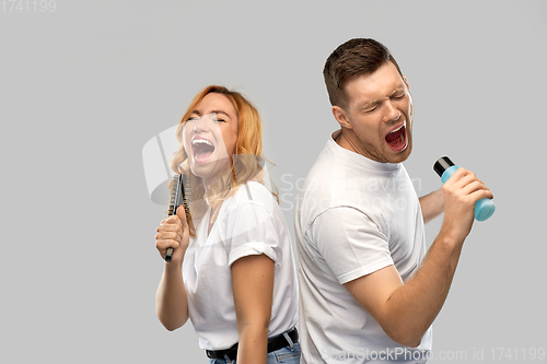 Image of happy couple singing to hairbrush and lotion