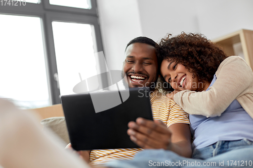 Image of happy couple with tablet pc computer at new home