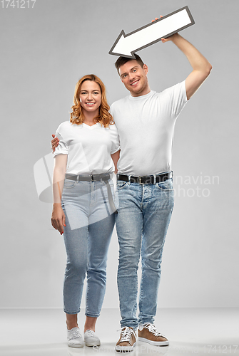 Image of happy couple in white t-shirts with arrow to left