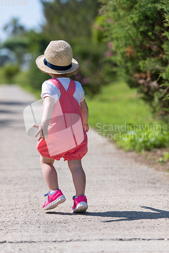 Image of little girl runing in the summer Park