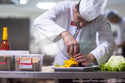 Image of chef serving vegetable salad