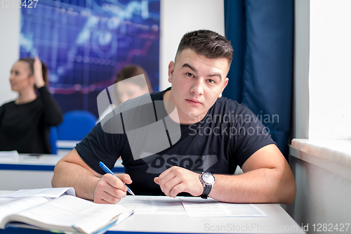 Image of male student writing notes