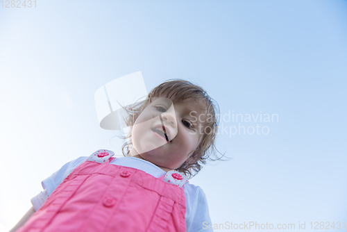 Image of little girl spending time at backyard