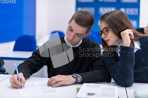 Image of young students writing notes