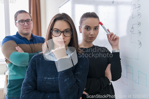 Image of portrait of young students in front of chalkboard