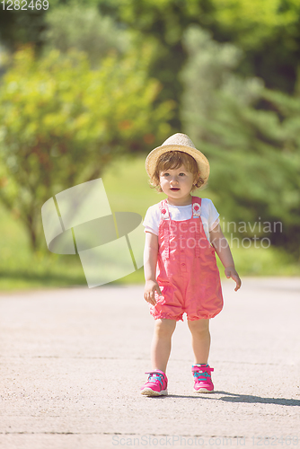 Image of little girl runing in the summer Park