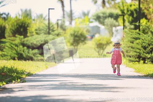 Image of little girl runing in the summer Park