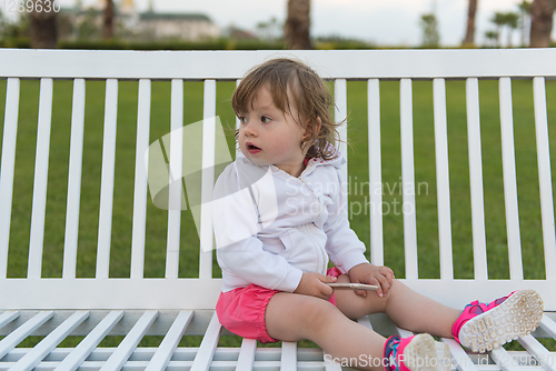 Image of little girl playing with mobile phone