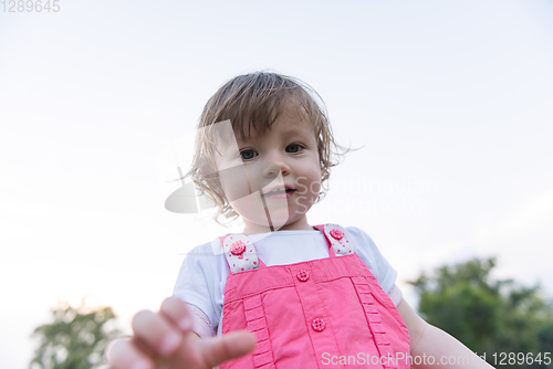 Image of little girl spending time at backyard
