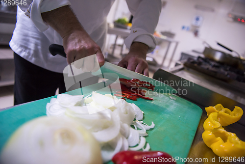 Image of Chef hands cutting fresh and delicious vegetables