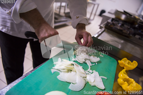 Image of Chef hands cutting fresh and delicious vegetables