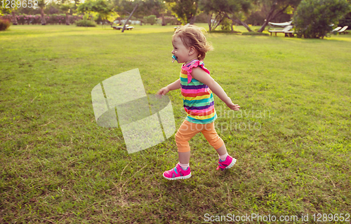 Image of little girl spending time at backyard