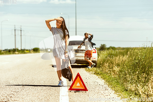 Image of Young couple traveling on the car in sunny day