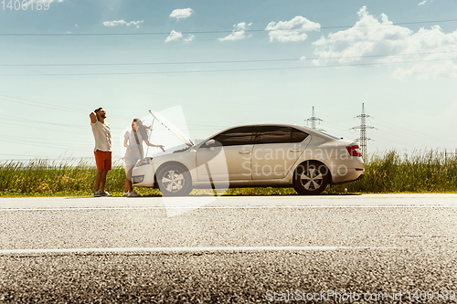 Image of Young couple traveling on the car in sunny day