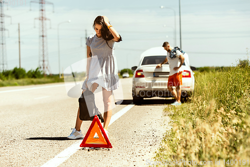 Image of Young couple traveling on the car in sunny day