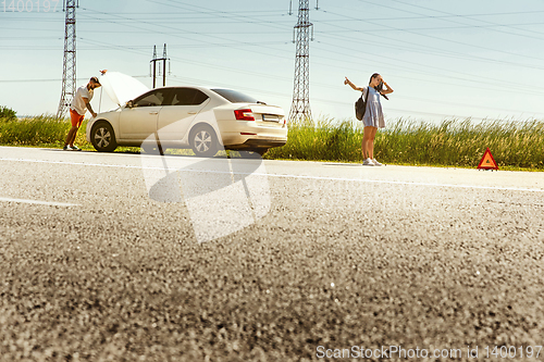 Image of Young couple traveling on the car in sunny day