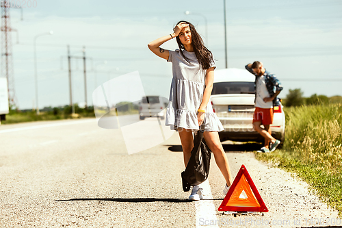 Image of Young couple traveling on the car in sunny day