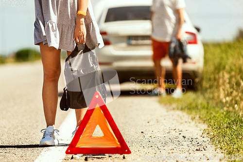 Image of Young couple traveling on the car in sunny day