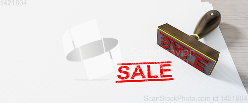 Image of red stamp sale on white paper background