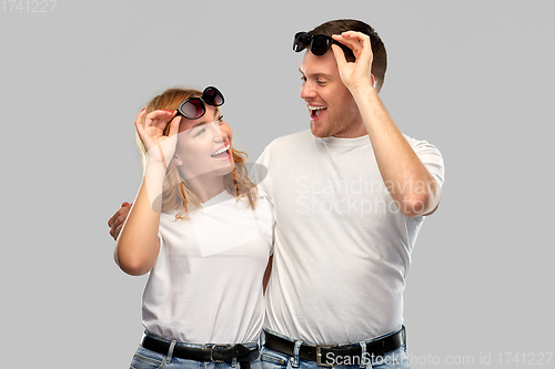 Image of happy couple in white t-shirts and sunglasses