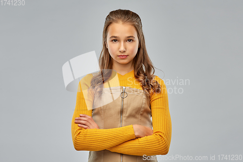 Image of serious young teenage girl with crossed arms