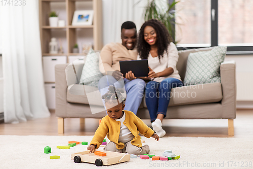 Image of family with tablet pc and toy blocks at home