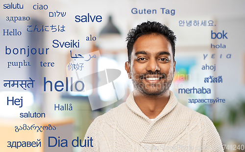 Image of indian man over words in foreign languages