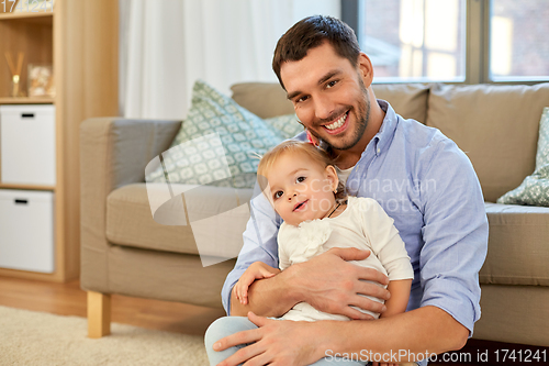 Image of father with little baby daughter at home