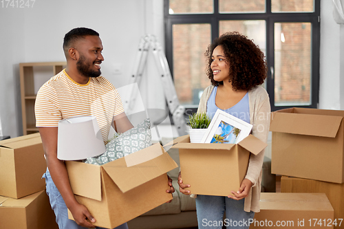 Image of happy couple with boxes moving to new home