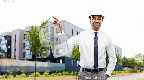 Image of architect in helmet pointing finger on city street