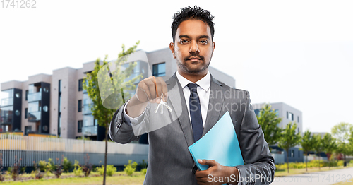 Image of indian man realtor with home keys on city street