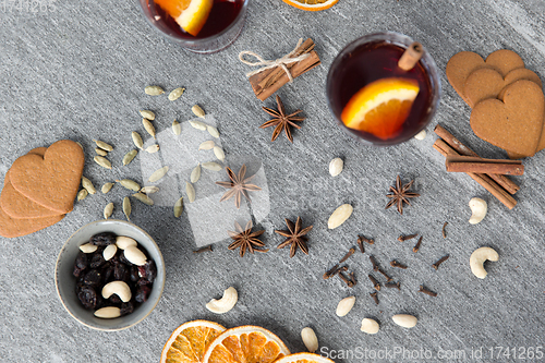 Image of hot mulled wine, orange slices, raisins and spices