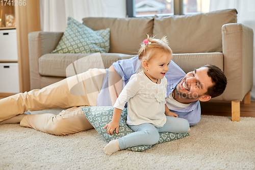 Image of father with little baby daughter at home