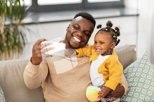 Image of happy father with baby taking selfie at home