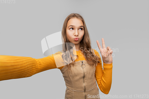 Image of funny teenage girl taking selfie and making faces