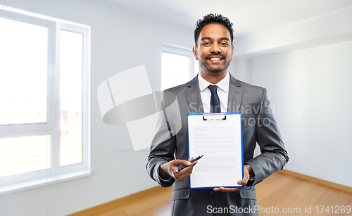 Image of indian man realtor with contract at new apartment