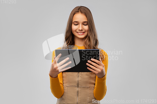 Image of teenage girl using tablet computer