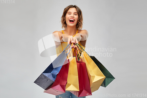 Image of happy smiling young woman with shopping bags