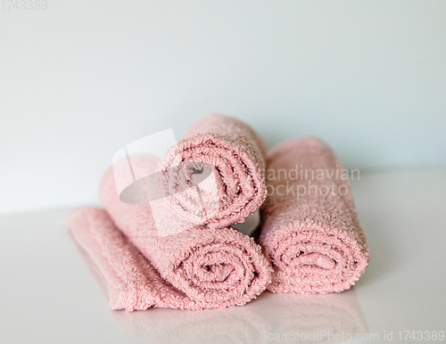 Image of pink bath towel rolls