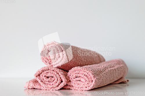 Image of pink bath towel rolls