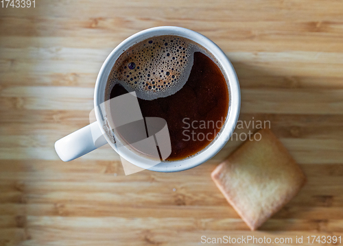 Image of cup of black coffee and cookie