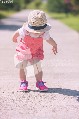 Image of little girl runing in the summer Park