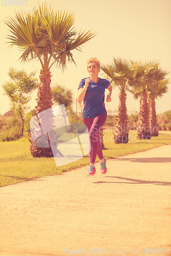 Image of young female runner training for marathon