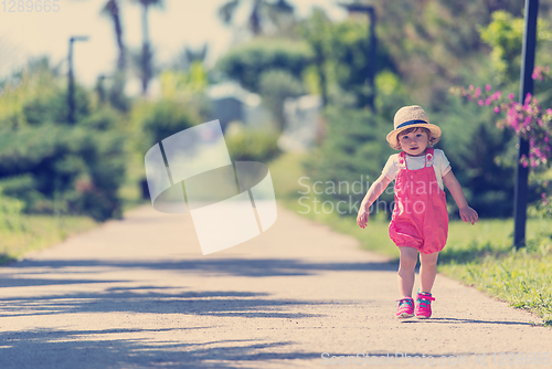 Image of little girl runing in the summer Park