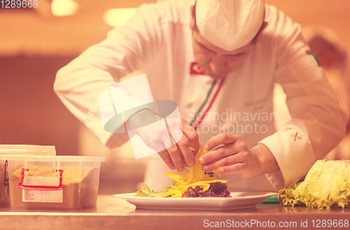 Image of chef serving vegetable salad