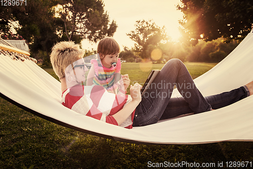 Image of mom and a little daughter relaxing in a hammock