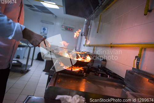 Image of Chef doing flambe on food